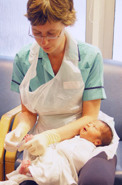 nurse caring for a baby and showing the compassion and technical expertise that lets nurses care
